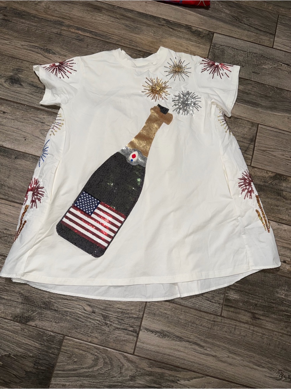 QUEEN OF SPARKLES White Sequin Champagne Bottle Tee with Flag and Fireworks